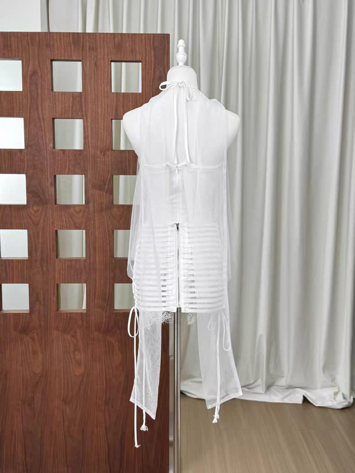 20260708160834_269_34 WHITE HALTER SHEER MESH LACE TOP & SIDE TIE BANDAGE MINI SKIRT SET